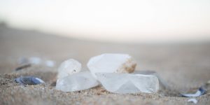 white crystals laying in sand